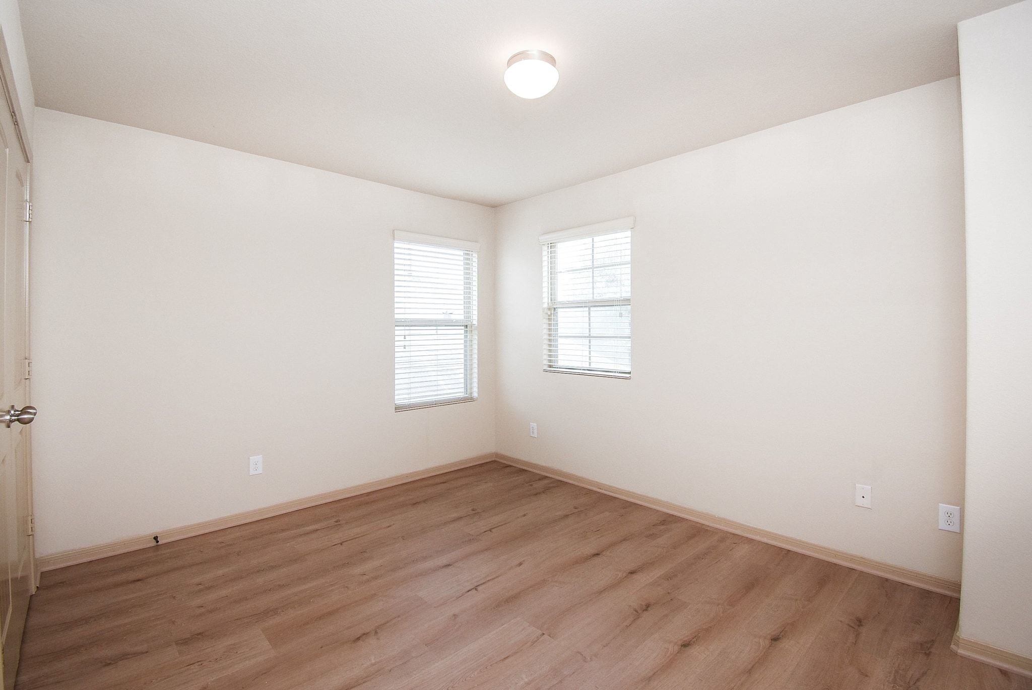 2106 Harmon Crest Court Spring, TX 77373 - Photo 35 of 37 an empty room with wooden floor and windows