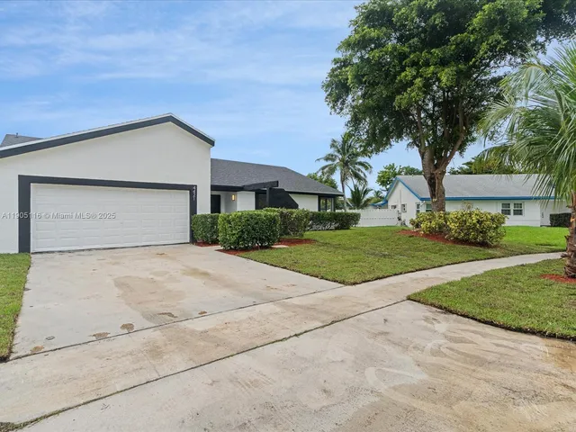 a view of garage yard and tree