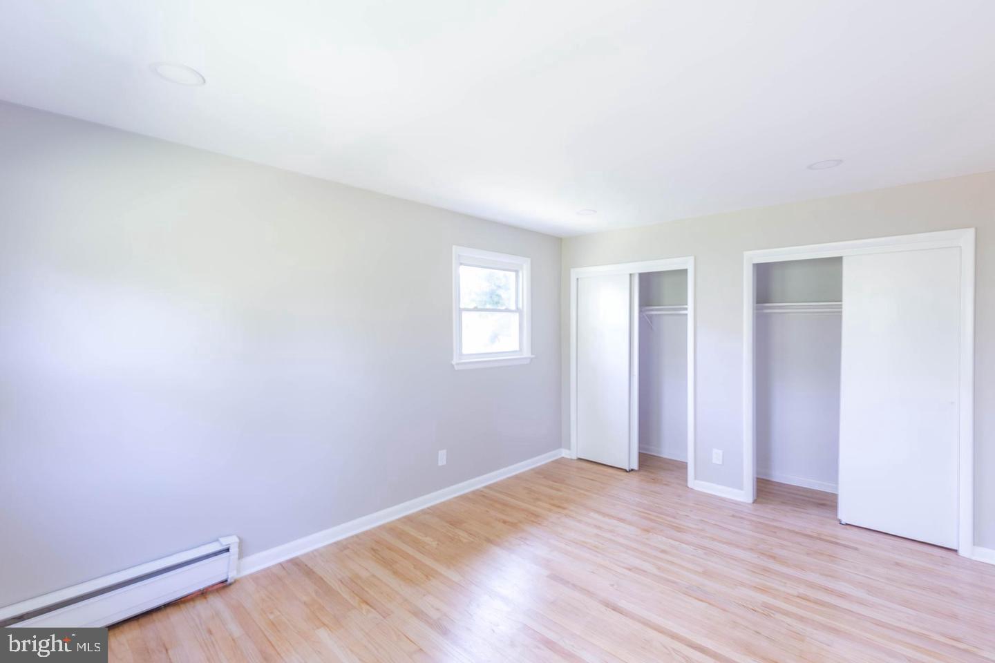 14698 Colchester Road Woodbridge, VA 22191 - Photo 11 of 15 an empty room with wooden floor and windows