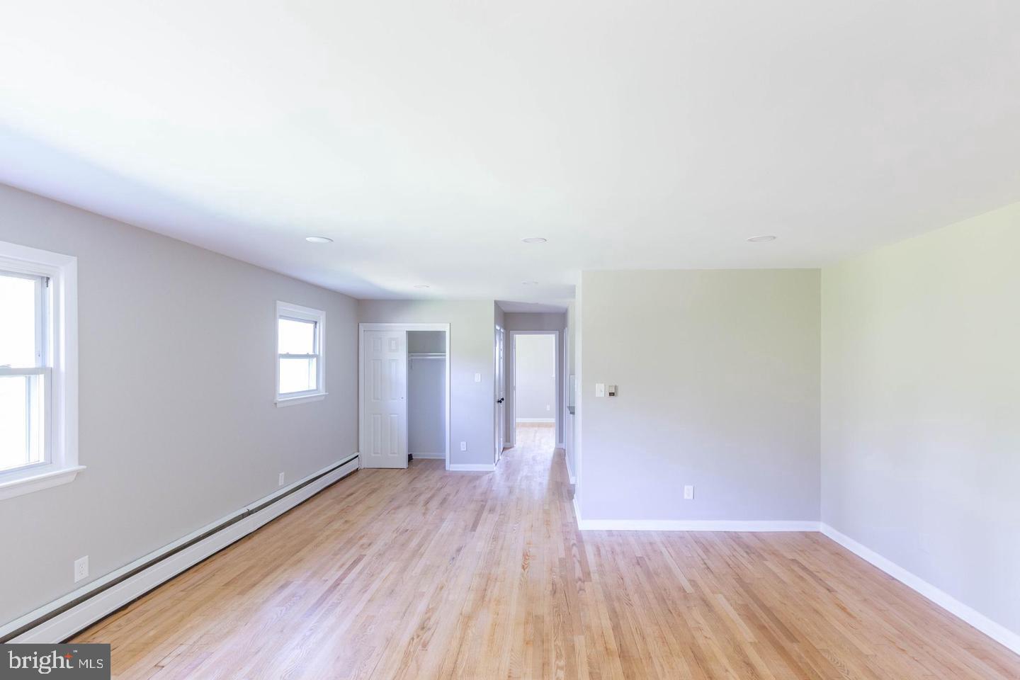 14698 Colchester Road Woodbridge, VA 22191 - Photo 5 of 15 an empty room with wooden floor and windows