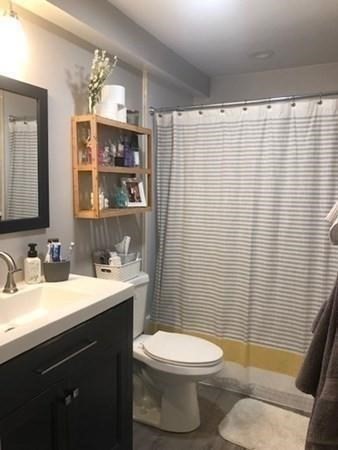 46 Silver Hill Lane, Unit 2 Natick, MA 01760 - Photo 11 of 23 a bathroom with a sink a toilet and shower curtain