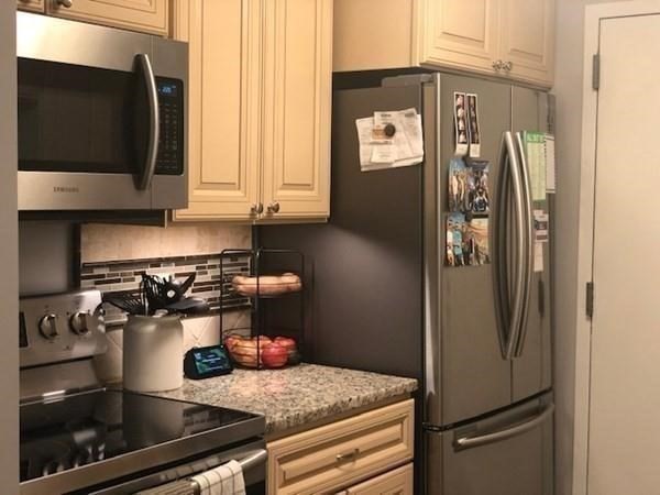 46 Silver Hill Lane, Unit 2 Natick, MA 01760 - Photo 12 of 23 a kitchen with a refrigerator and a stove