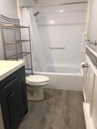 46 Silver Hill Lane, Unit 2 Natick, MA 01760 - Photo 15 of 23 a bathroom with a granite countertop sink toilet and shower