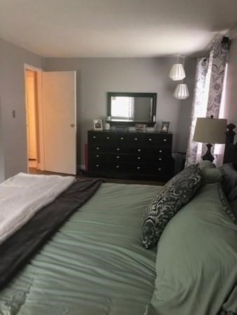 46 Silver Hill Lane, Unit 2 Natick, MA 01760 - Photo 17 of 23 a bedroom with a bed and a flat tv screen on dresser