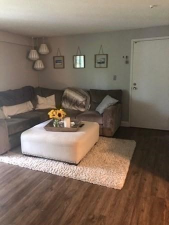46 Silver Hill Lane, Unit 2 Natick, MA 01760 - Photo 4 of 23 a living room with furniture and a wooden floor