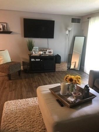 46 Silver Hill Lane, Unit 2 Natick, MA 01760 - Photo 5 of 23 a living room with furniture and a flat screen tv