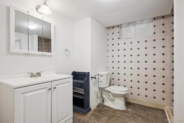 a bathroom with a sink toilet and a mirror