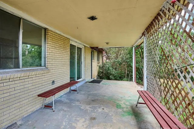 a view of a yard with wooden fence