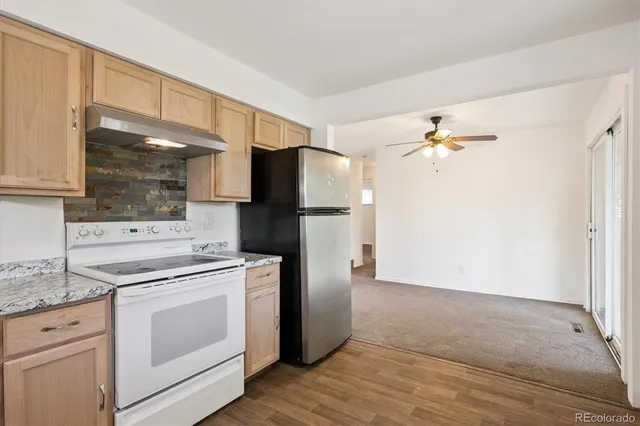 a kitchen with a stove cabinets and refrigerator