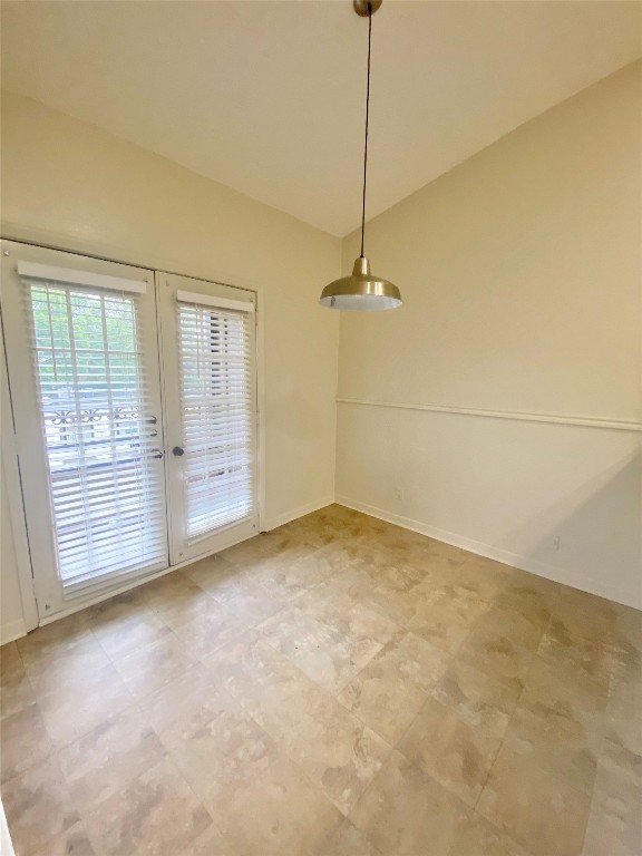 2216 San Gabriel Street, Unit 304 Austin, TX 78705 - Photo 17 of 24 Unfurnished dining area featuring baseboards and lofted ceiling