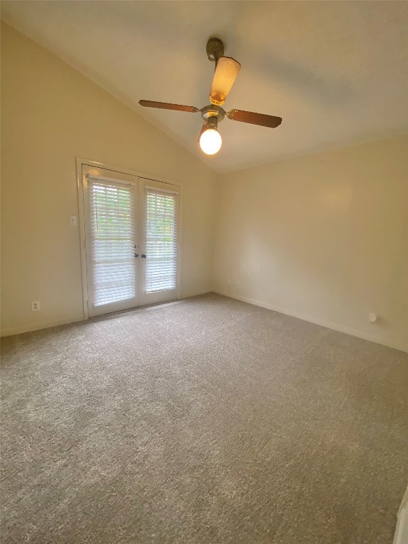 2216 San Gabriel Street, Unit 304 Austin, TX 78705 - Photo 20 of 24 Carpeted spare room featuring baseboards, a ceiling fan, french doors, and lofted ceiling