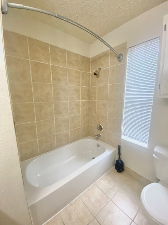 2216 San Gabriel Street, Unit 304 Austin, TX 78705 - Photo 23 of 24 Full bath featuring tile patterned floors, a textured ceiling, toilet, and shower / tub combination