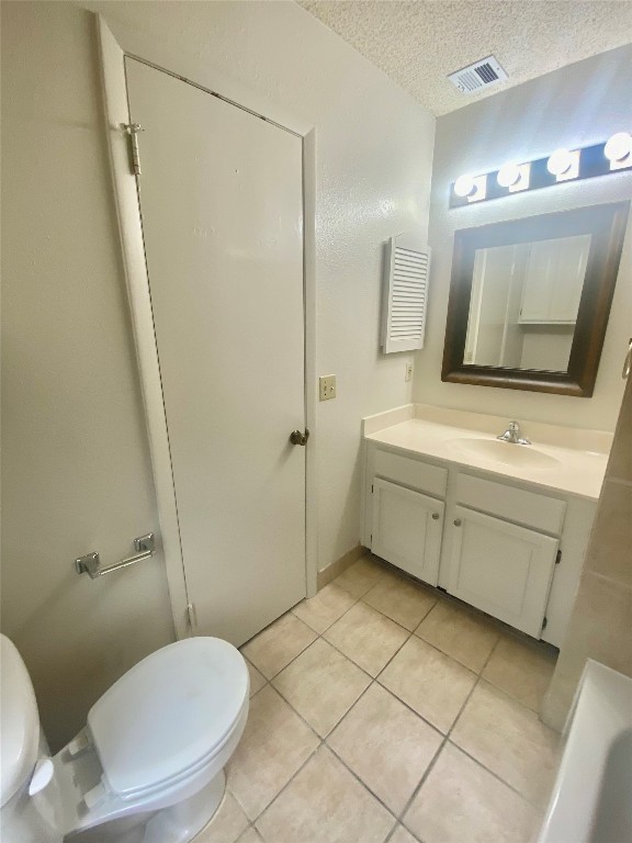 2216 San Gabriel Street, Unit 304 Austin, TX 78705 - Photo 24 of 24 Bathroom featuring tile patterned flooring, vanity, toilet, visible vents, and a textured ceiling
