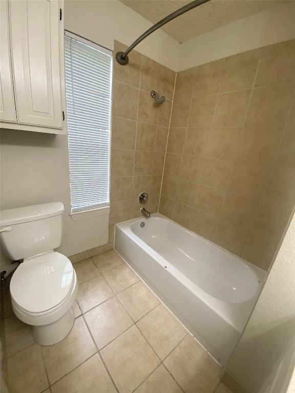 2216 San Gabriel Street, Unit 304 Austin, TX 78705 - Photo 10 of 24 Bathroom featuring shower / tub combination, toilet, a textured ceiling, baseboards, and tile patterned flooring