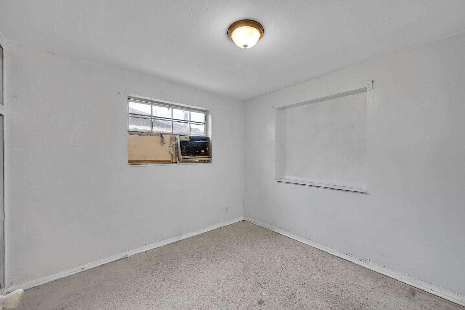 1645 West 31st Street Riviera Beach, FL 33404 - Photo 13 of 20 an empty room with a window