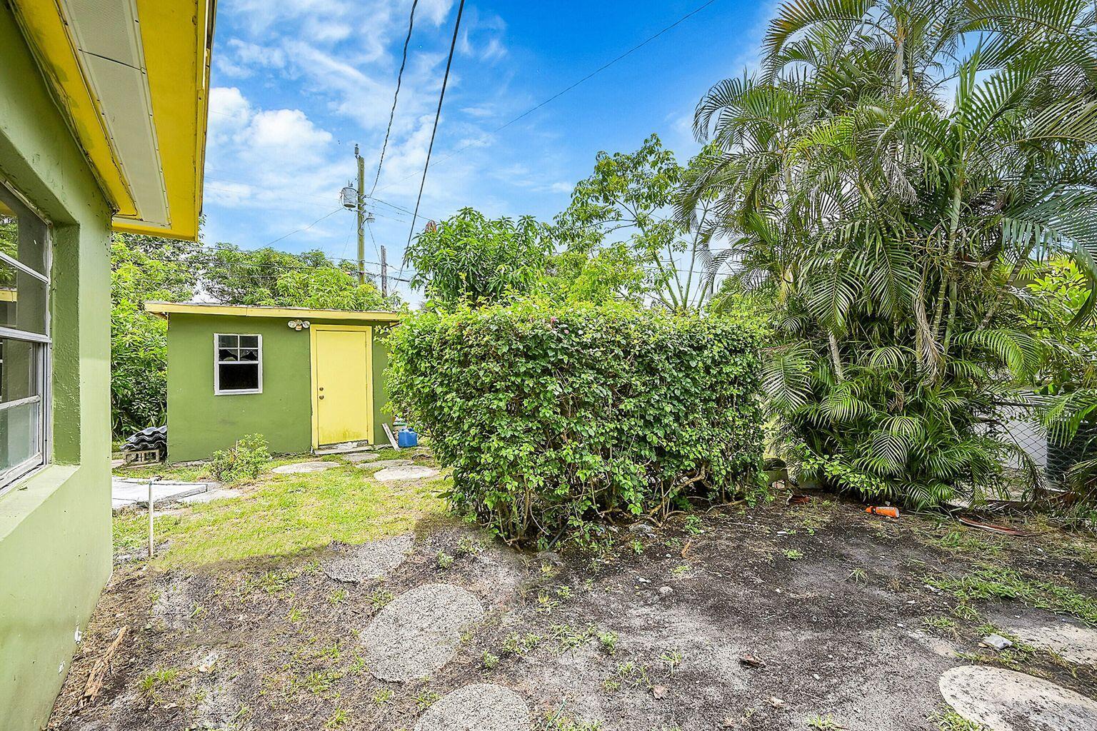 1645 West 31st Street Riviera Beach, FL 33404 - Photo 17 of 20 a view of a house with backyard and sitting area