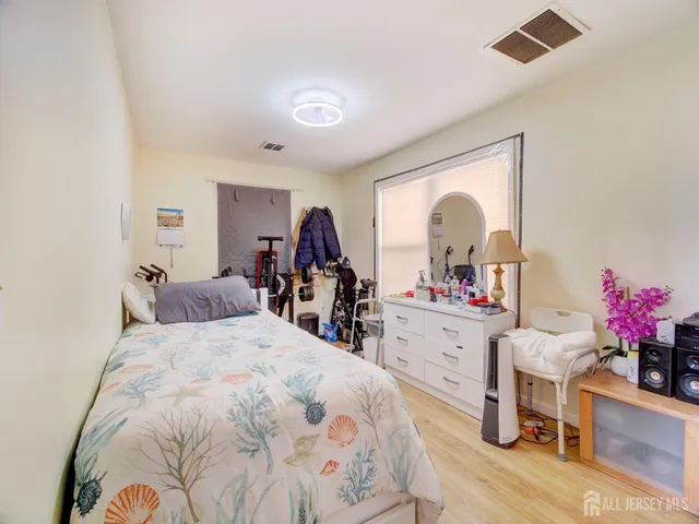 a bed room with a bed mirror and desk