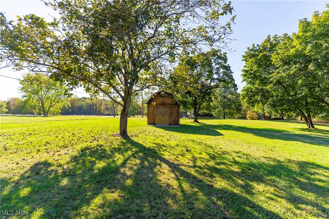 1835 Homeworth Road Alliance, OH 44601 - Photo 26 of 32 View of grassy yard featuring a shed