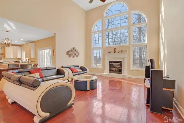 a living room with furniture a fireplace and a large window