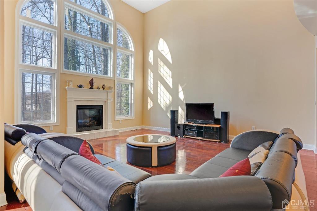 14 Harding Avenue Edison, NJ 08820 - Photo 15 of 41 a living room with furniture a flat screen tv and a fireplace