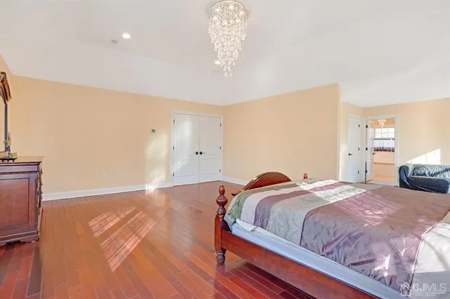 a bedroom with a bed and a chandelier
