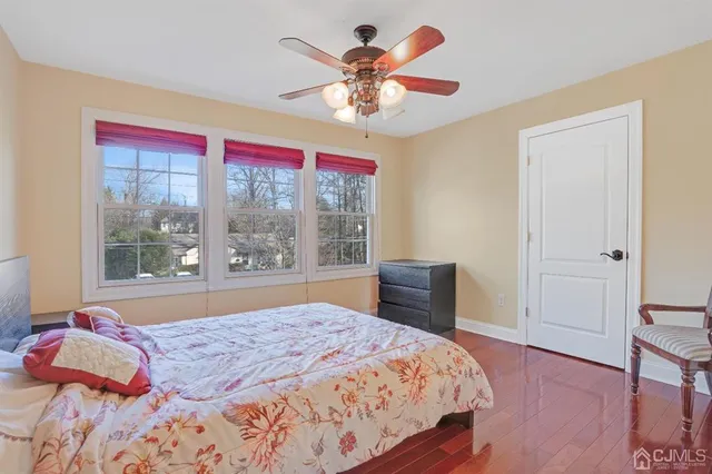 a bedroom with a large bed and a large window