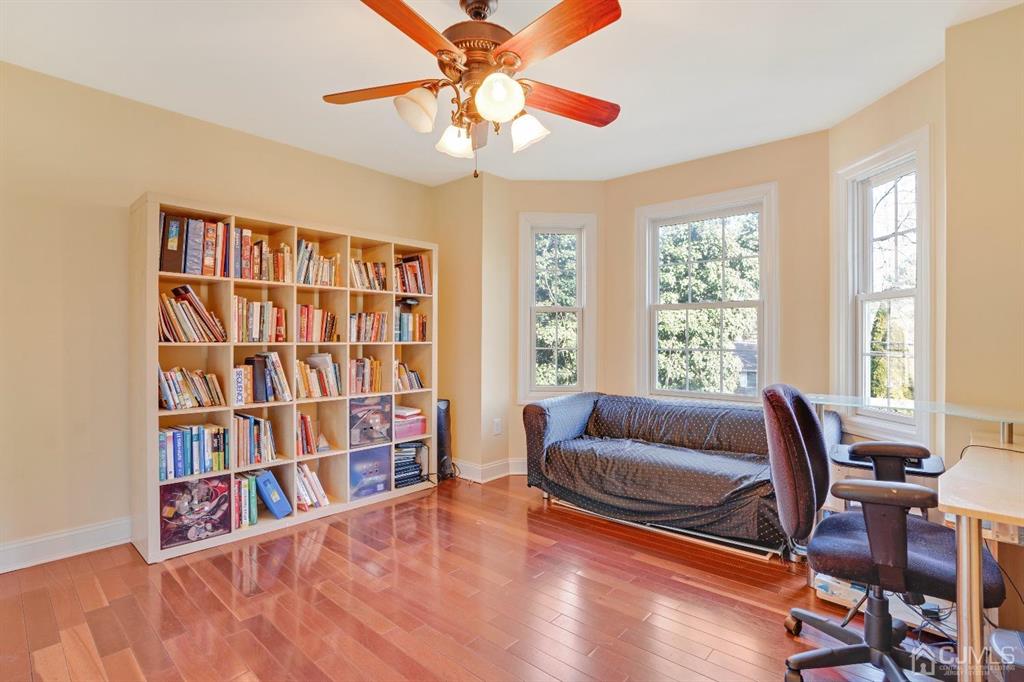 14 Harding Avenue Edison, NJ 08820 - Photo 33 of 41 a living room with furniture and a book shelf