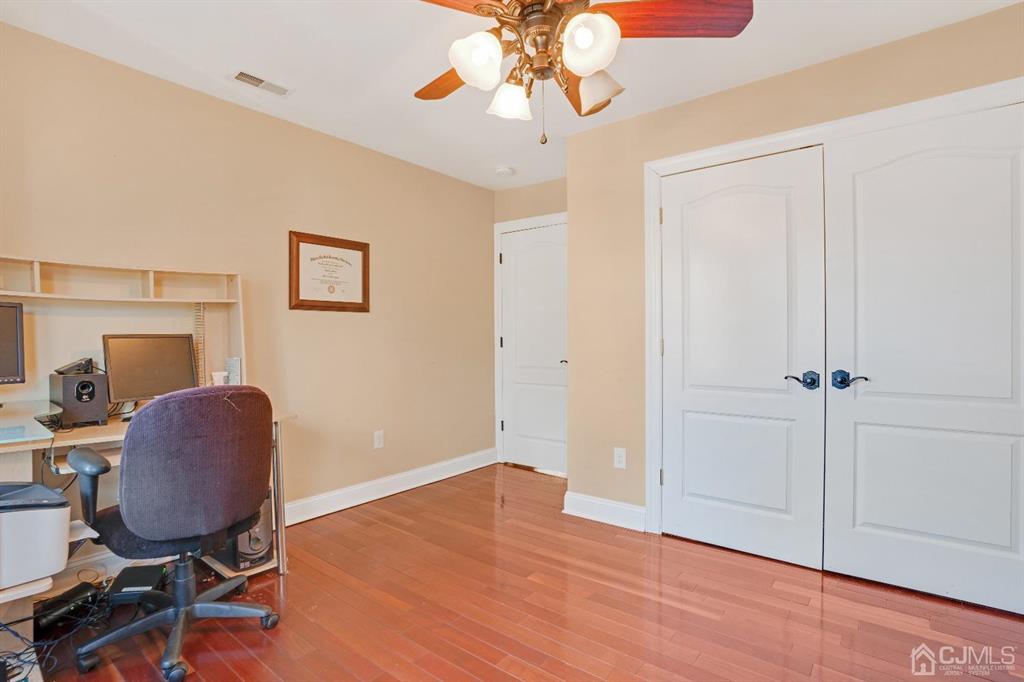 14 Harding Avenue Edison, NJ 08820 - Photo 34 of 41 a workspace with wooden floor and a chandelier fan