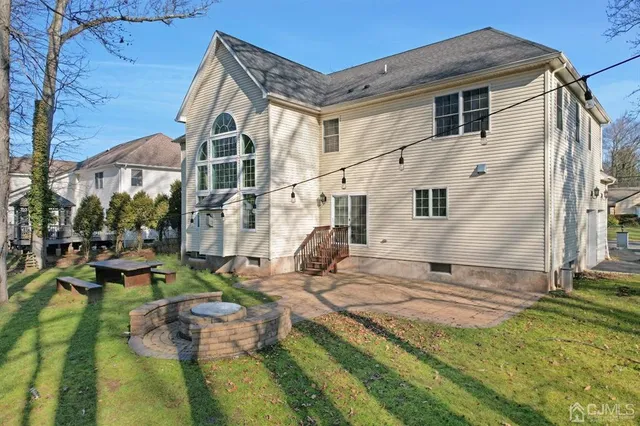 a view of a house with backyard and sitting area