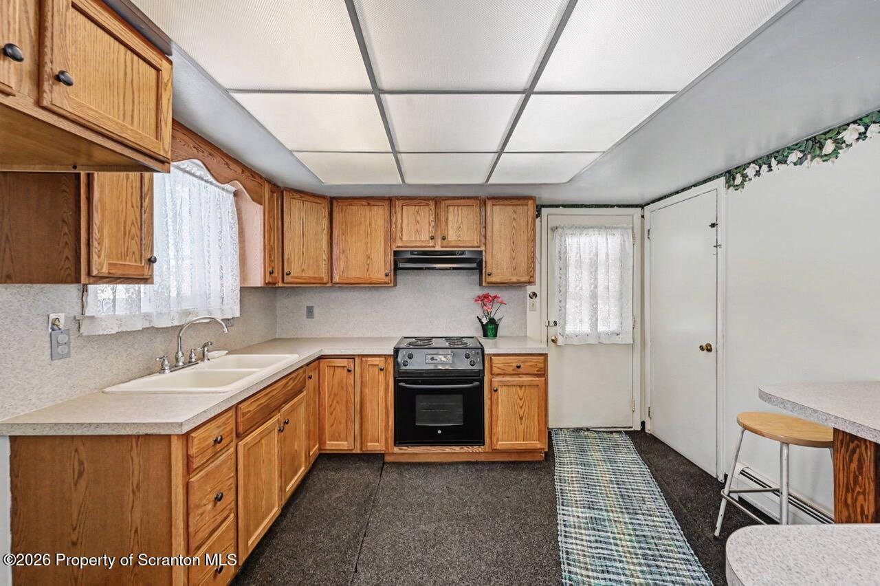 30 Glinko Street Scranton, PA 18504 - Photo 12 of 41 a kitchen with stainless steel appliances granite countertop a sink and cabinets