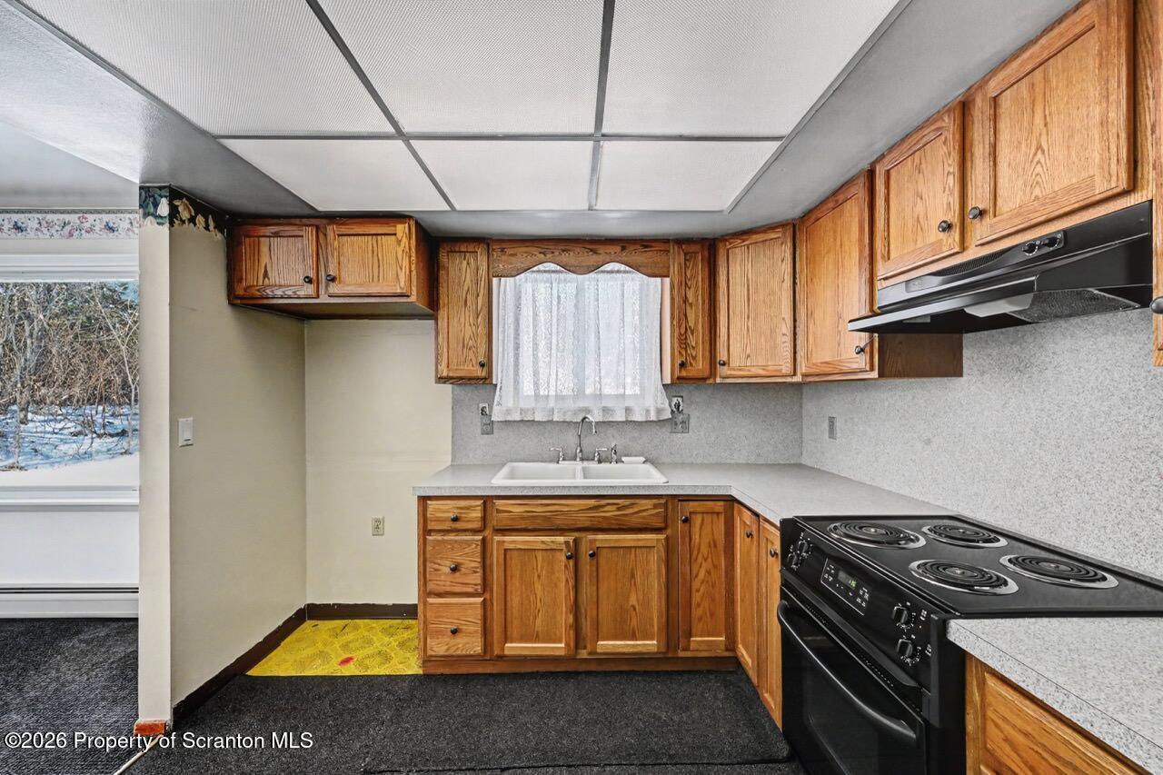30 Glinko Street Scranton, PA 18504 - Photo 13 of 41 a kitchen with stainless steel appliances granite countertop a stove a sink dishwasher and cabinets with wooden floor