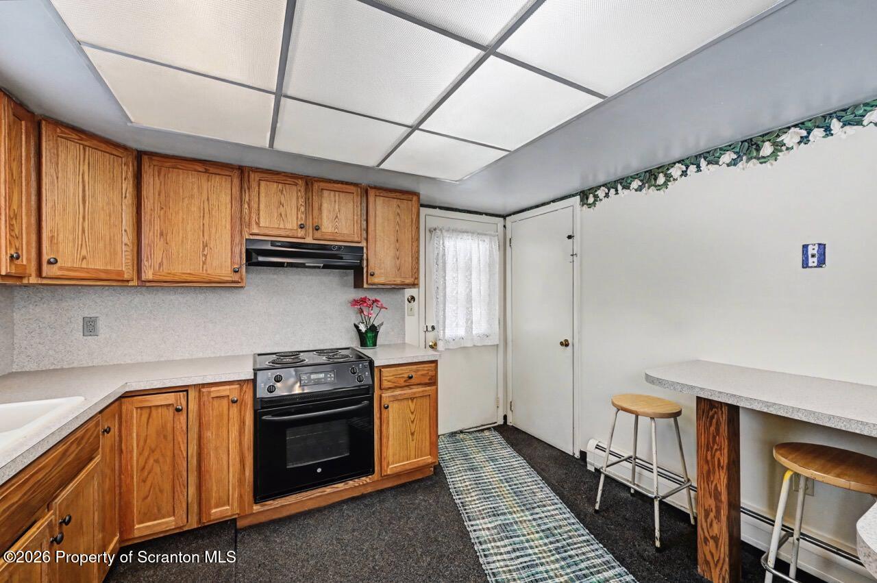 30 Glinko Street Scranton, PA 18504 - Photo 18 of 41 a kitchen with wooden cabinets and a stove top oven