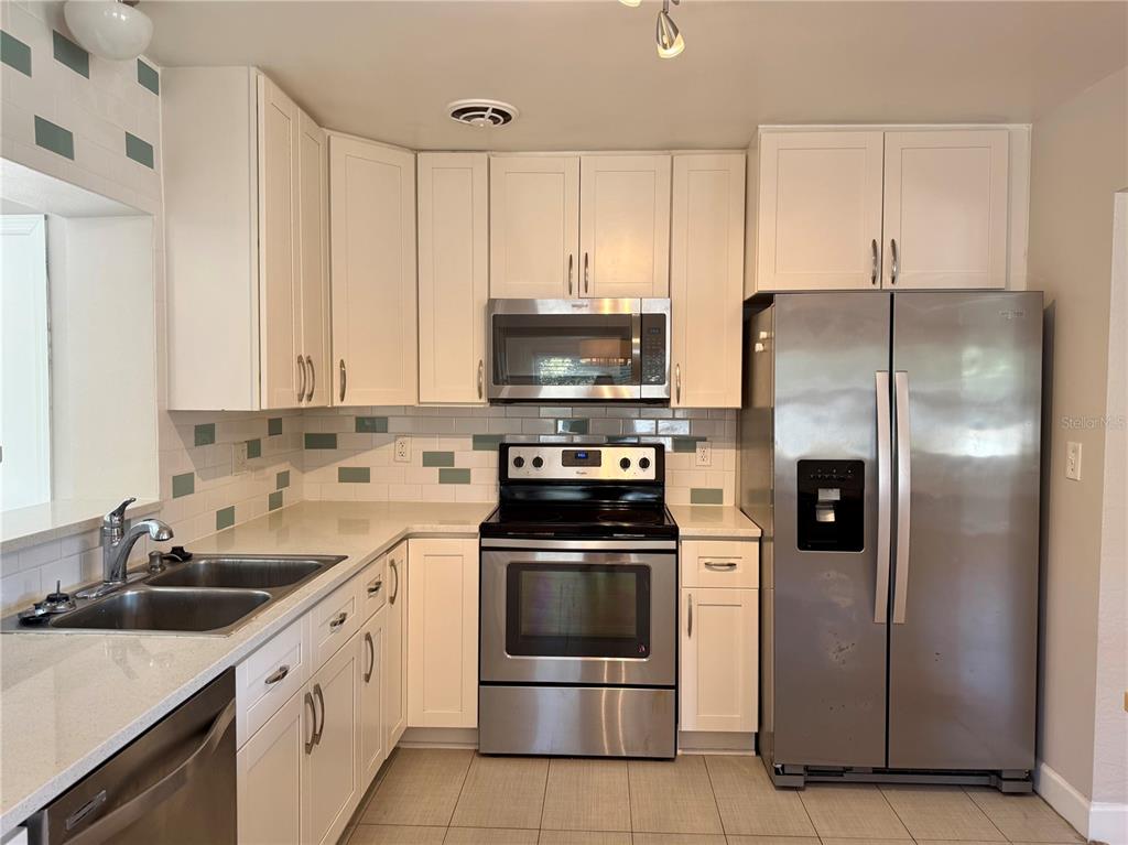 2801 Nancy Street Orlando, FL 32806 - Photo 2 of 39 a kitchen with a sink stove and refrigerator