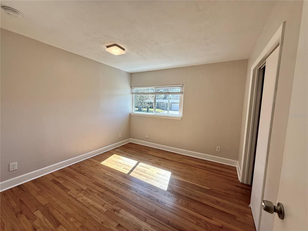 2801 Nancy Street Orlando, FL 32806 - Photo 22 of 39 an empty room with wooden floor and windows