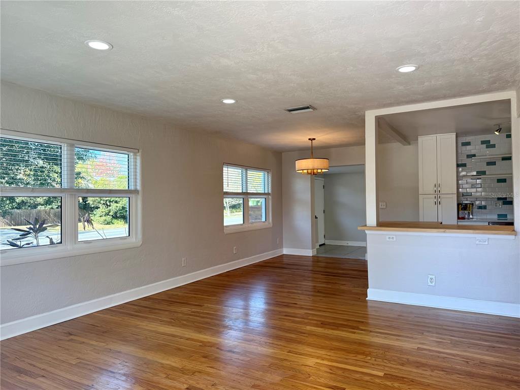 2801 Nancy Street Orlando, FL 32806 - Photo 3 of 39 an empty room with wooden floor and windows