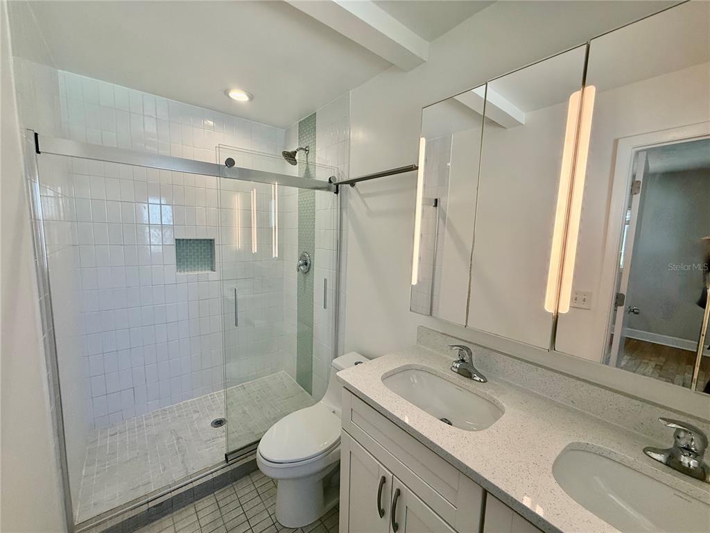 2801 Nancy Street Orlando, FL 32806 - Photo 6 of 39 a bathroom with a sink toilet a mirror and shower