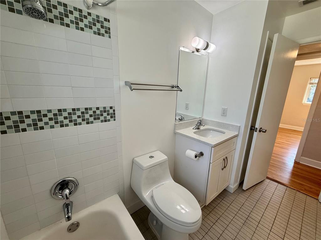 2801 Nancy Street Orlando, FL 32806 - Photo 10 of 39 a bathroom with a sink a toilet a mirror and shower