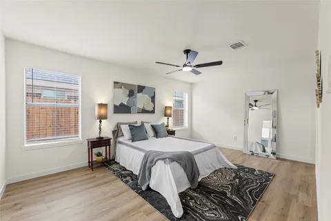 a bedroom with a large bed chandelier and a window