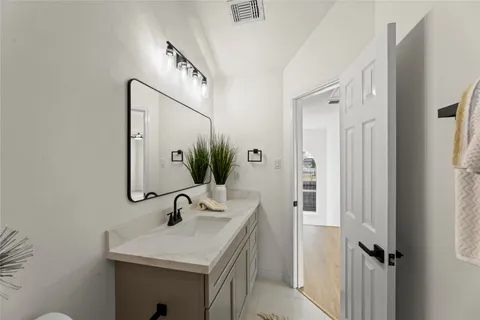 a bathroom with a sink a mirror and vanity