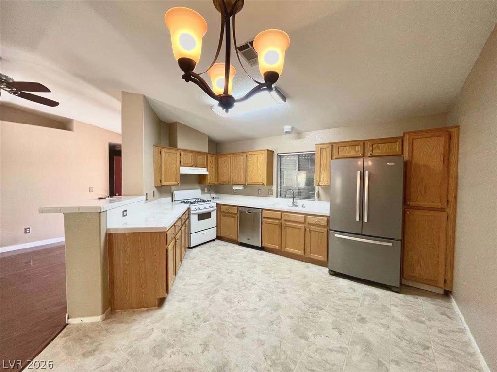3500 Redwood Ridge Way North Las Vegas, NV 89031 - Photo 4 of 13 A well-equipped kitchen offers ample cabinet storage and modern stainless steel appliances.