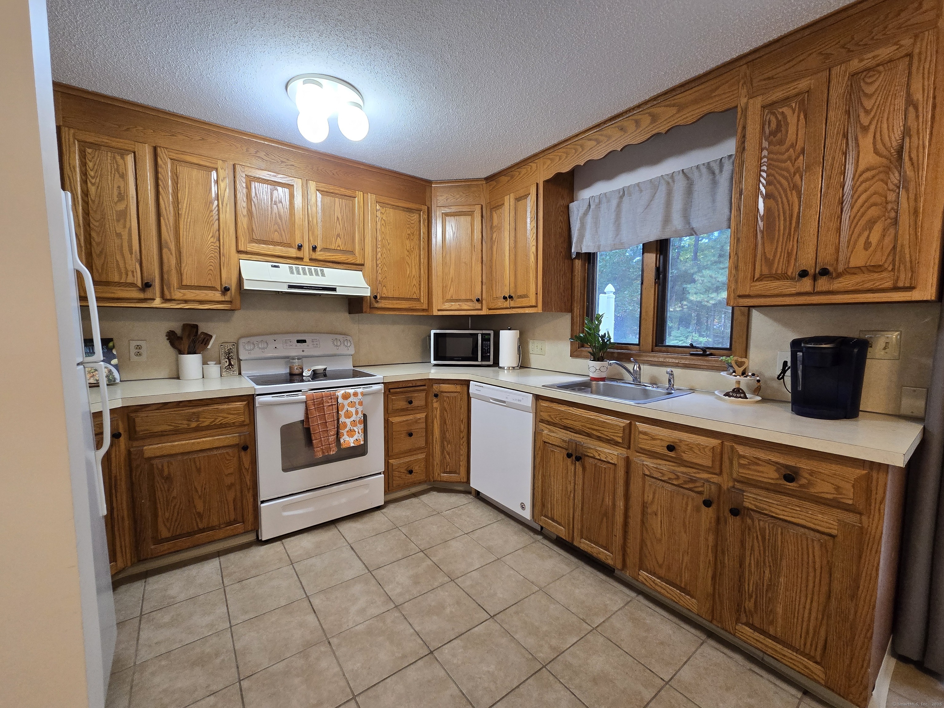 85 Oldefield Farms, Unit 85 Enfield, CT 06082 - Photo 12 of 36 a kitchen with stainless steel appliances granite countertop a stove sink and cabinets