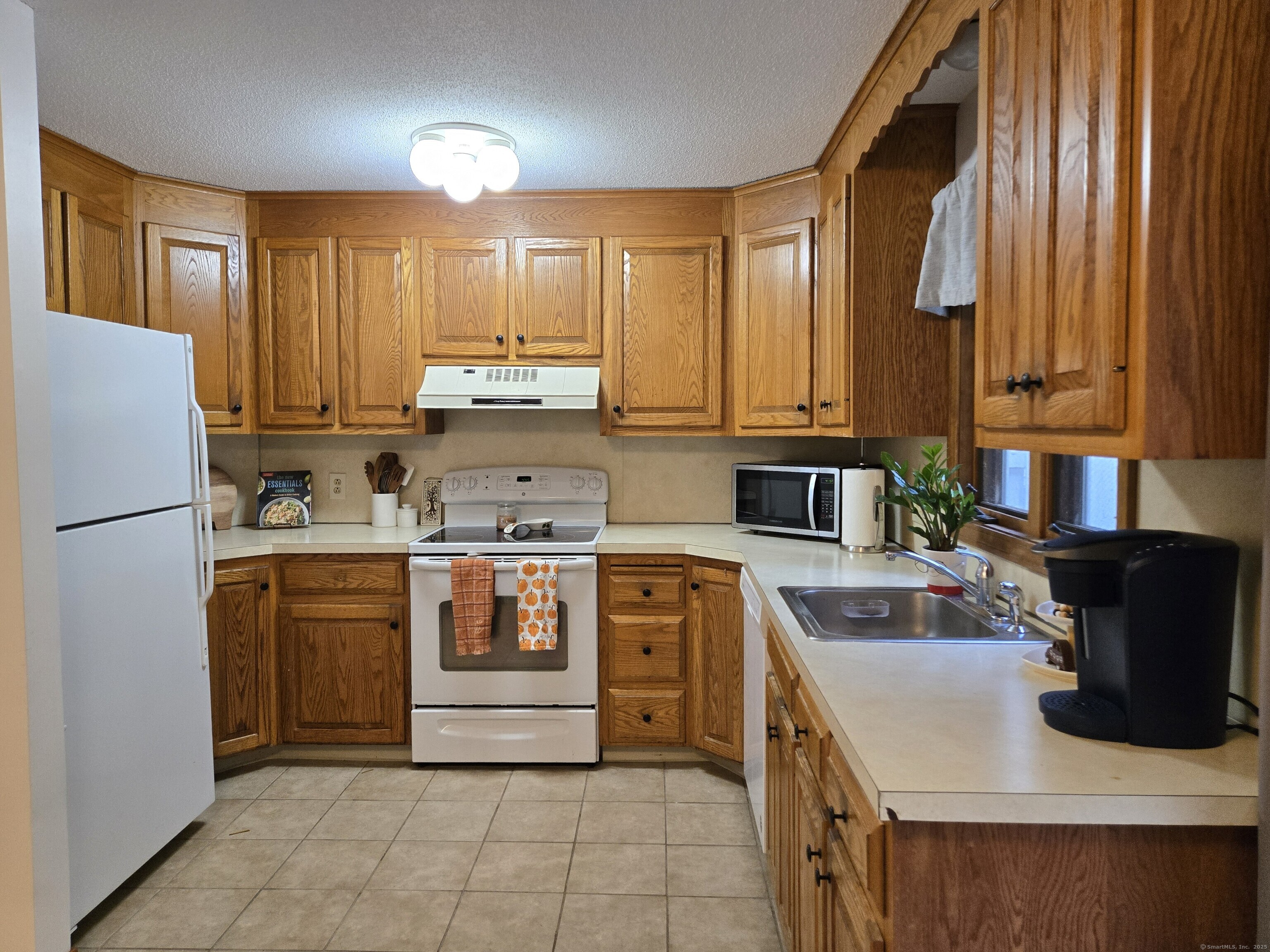 85 Oldefield Farms, Unit 85 Enfield, CT 06082 - Photo 13 of 36 a kitchen with stainless steel appliances granite countertop a refrigerator sink and stove