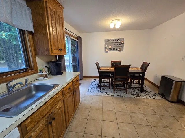 a view of a kitchen with kitchen island dining table and chairs