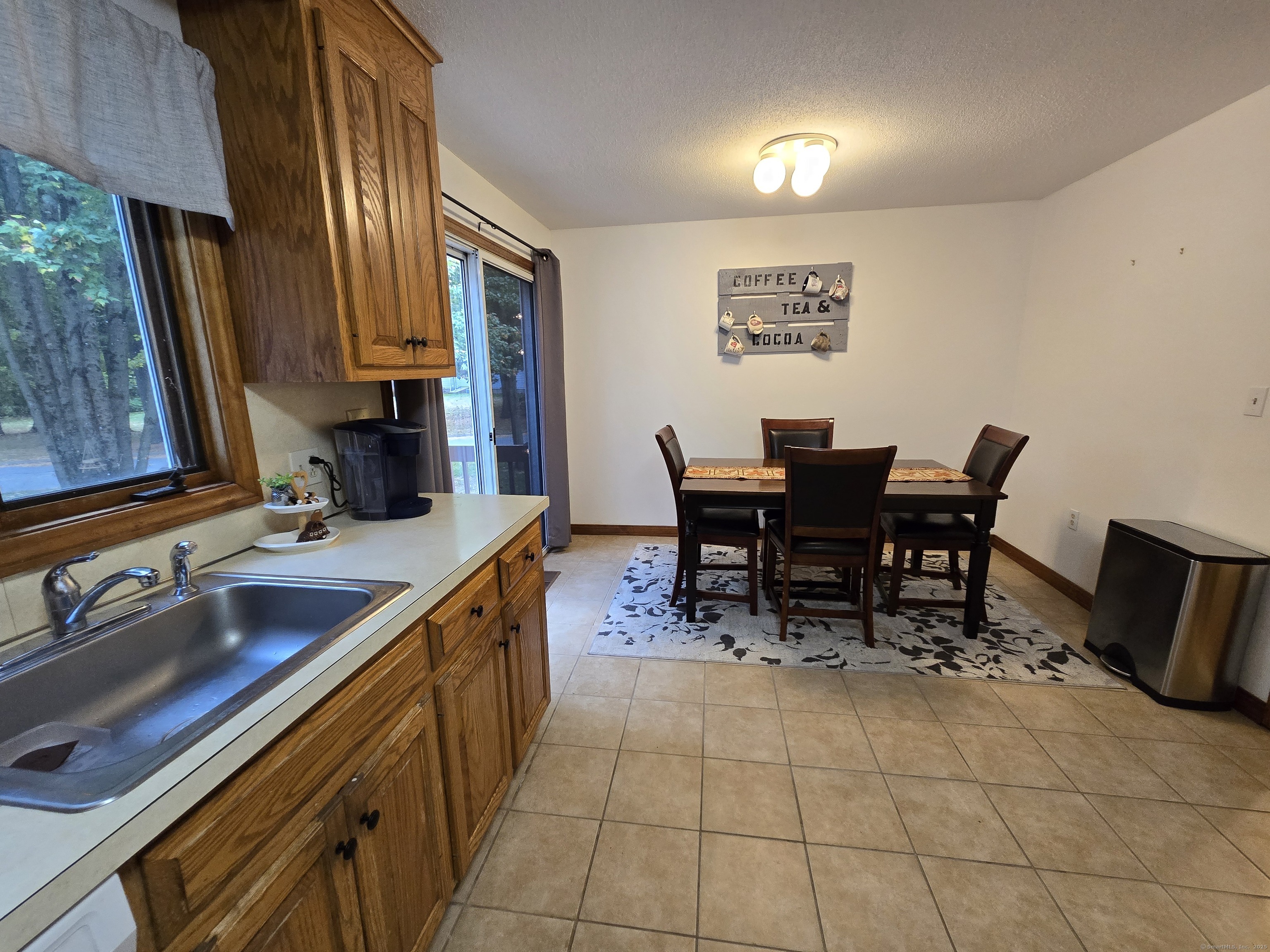 85 Oldefield Farms, Unit 85 Enfield, CT 06082 - Photo 16 of 36 a view of a kitchen with kitchen island dining table and chairs