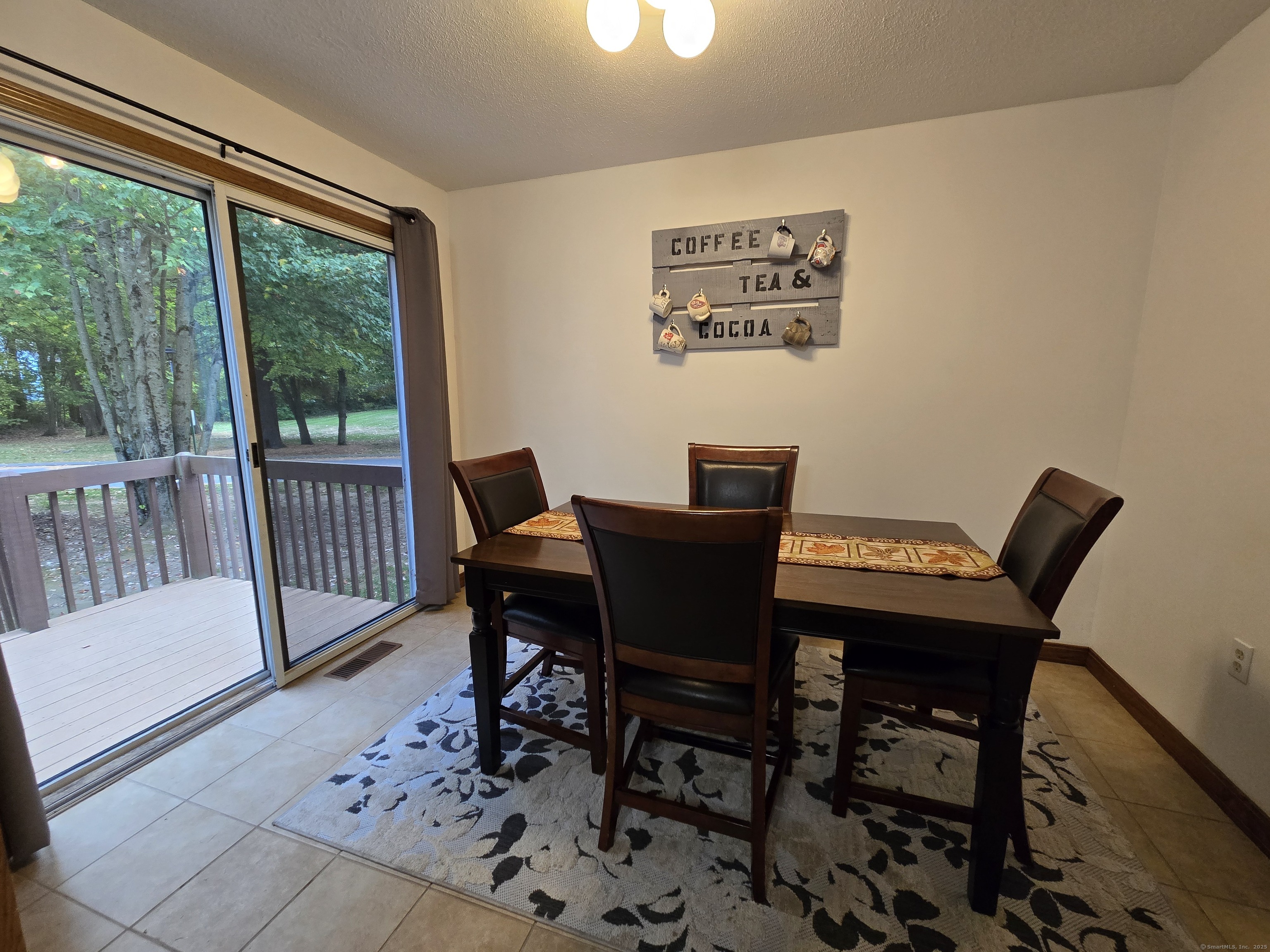 85 Oldefield Farms, Unit 85 Enfield, CT 06082 - Photo 17 of 36 a view of a dining room with furniture window and outside view