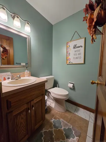 a bathroom with a sink mirror vanity and toilet
