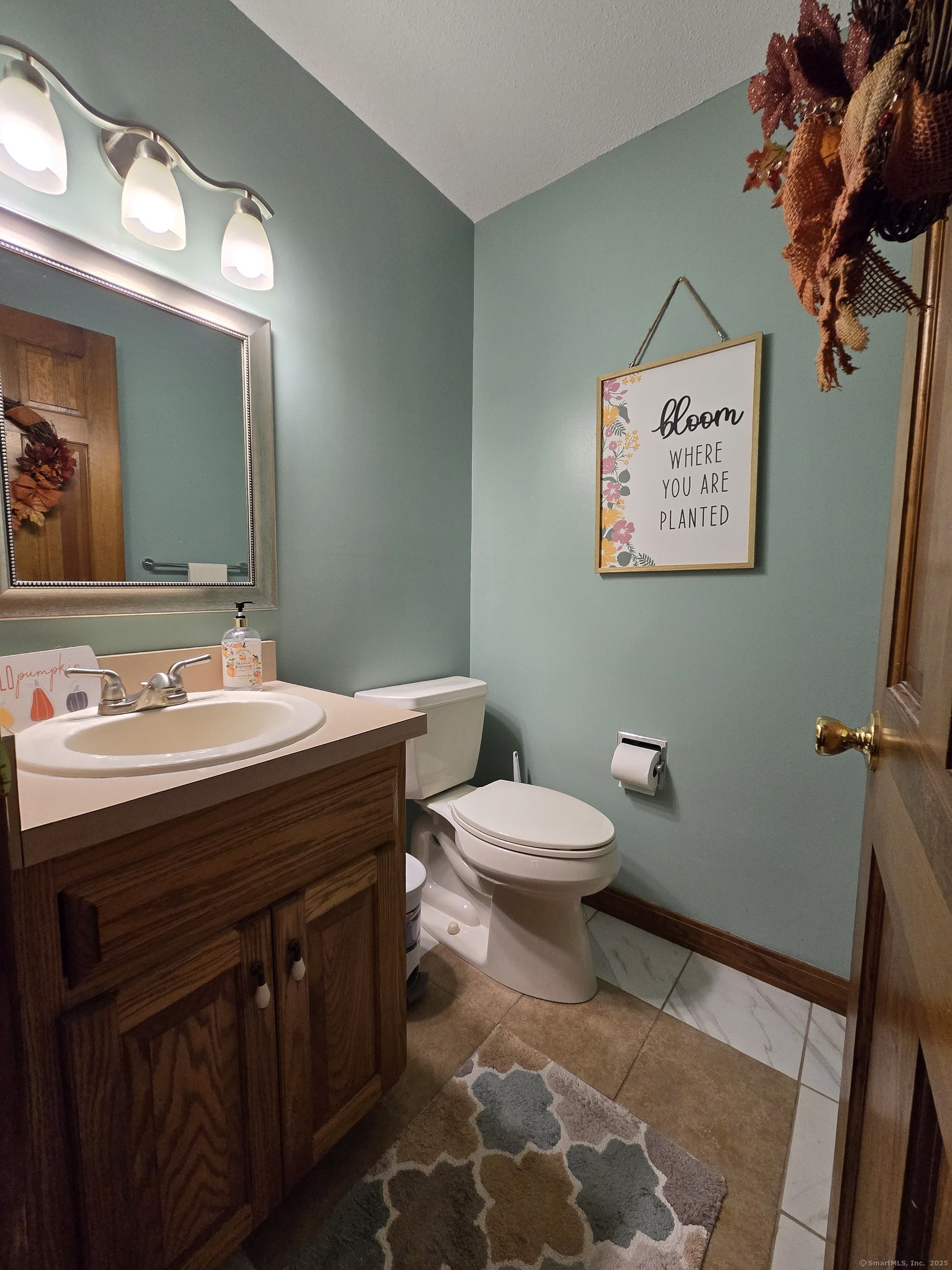 85 Oldefield Farms, Unit 85 Enfield, CT 06082 - Photo 18 of 36 a bathroom with a sink mirror vanity and toilet