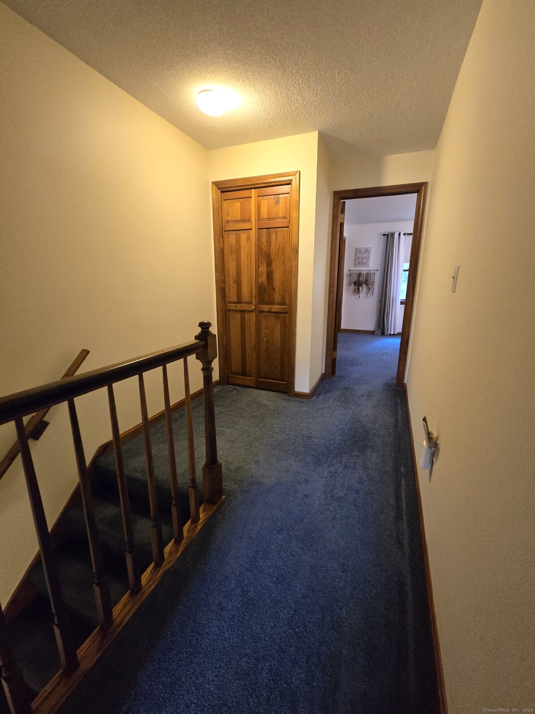 85 Oldefield Farms, Unit 85 Enfield, CT 06082 - Photo 20 of 36 a view of a hallway with wooden shelves