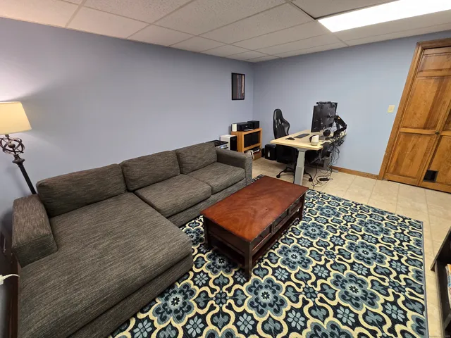 a living room with furniture and a rug