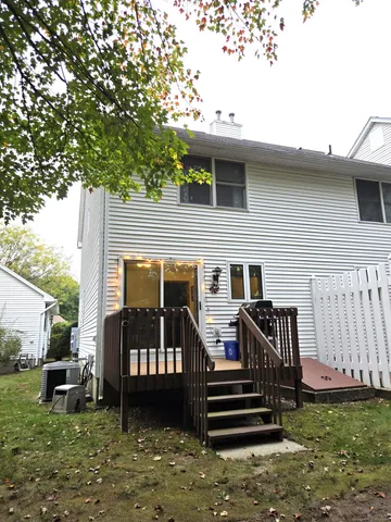 a view of a house with a wooden deck